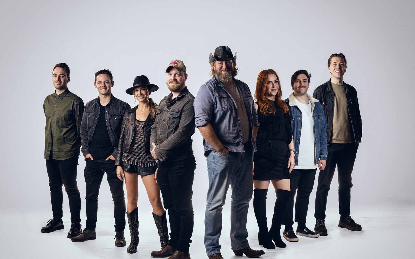 The eight members of Nashville At Heart photographed together in a white studio